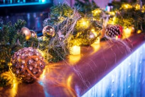 Festive foliage on a bar with lights for those looking for New Year's Eve events in Maidstone. For Mu Mu Experience in Kent