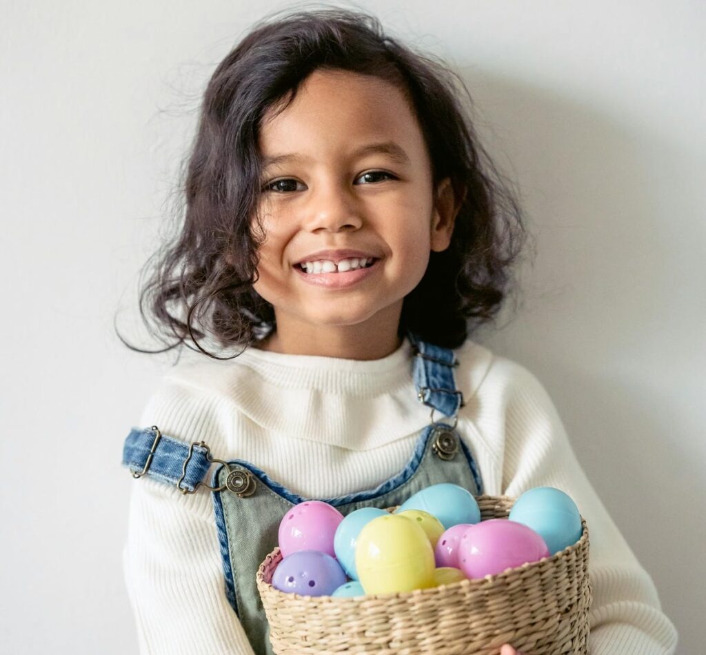 Young girl holding a basket of coloured eggs for Easter Events in Kent and Easter Egg hunts and Easter trails