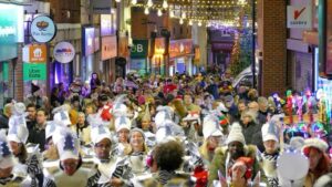 Crowds of people walking in a town centre for Ramsgate New Year's Eve Winter Parade in Kent