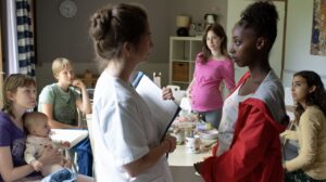 Group of young women one holding a baby, another pregnant and a nurse with a clipboard for new film releases for cinemas in Kent and Young Mothers from Curzon 