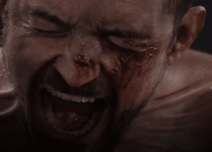 Close up of a man with a bloodied face as if screaming for new film releases in cinemas in Kent and The Cut from Altitude Film