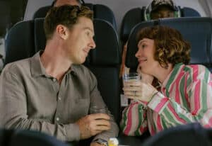 A couple in plane seats looking at each other for new film releases for cinemas in Kent and THE ROSES from Walt Disney