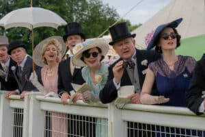 People dressed up at the races leaning on a fence and looking down for New film releases for cinemas in Kent and Downton Abbey- The Grand Finale from Universal Pictures.