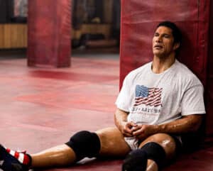 Man in a T-Shirt with sitting against a wall with legs out for New film releases for cinemas in Kent and the The Smashing Machine - from Entertainment Film Distributors
