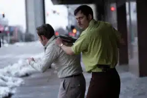 man holding a shotgun to the back of another man for New Releases Film Guide for the Dead Man's Wire movie.