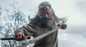 Man with grey hair and beard holding an axe for the Robin Hood in the New Film Releases in Kent Guide